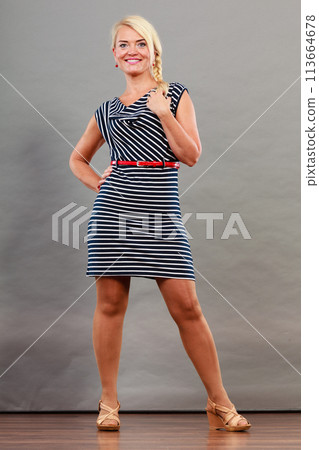 Mid adult woman in summer striped dress 113664678