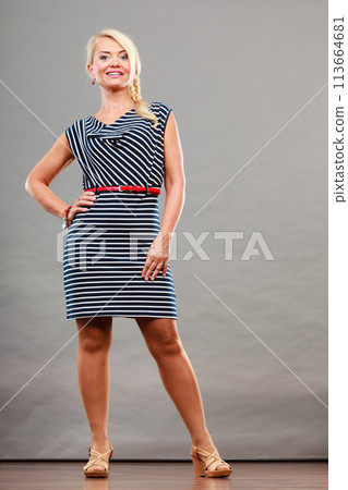 Mid adult woman in summer striped dress 113664681