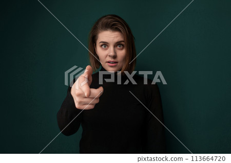 Woman Pointing at Camera on Green Background Woman Pointing at Camera on Green Background 113664720