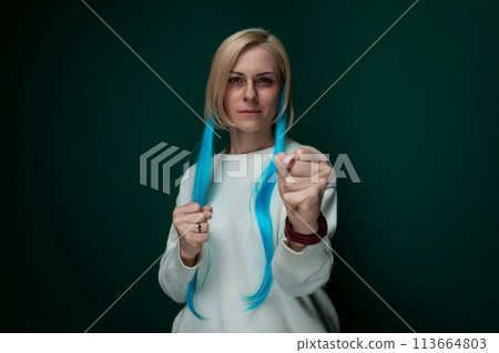 Woman With Long Blue Hair Holding a Pair of Scissors Woman With Long Blue Hair Holding a Pair of Scissors 113664803