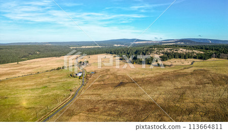 Blatna irrigation canal in the middle of autumn landscape at Ryzovna, Ore Mountains, Czech: Krusne hory, Czechia. Aerial view from drone. 113664811