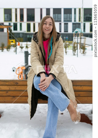 Woman Sitting on a Bench in the Snow Woman Sitting on a Bench in the Snow 113665059