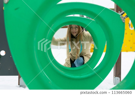 Woman Seen Through Green Sculpture 113665060