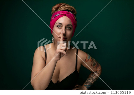 Woman in Pink Turban Making a Hush Gesture 113665119