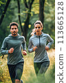 Man and Woman Running in the Woods 113665128
