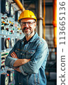Man in Hard Hat Standing in Front of Control Panel 113665136