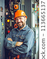 Man in Hard Hat Standing in Front of Control Panel 113665137