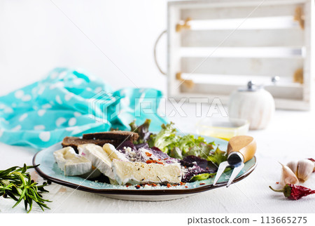 Camambert, beet salad and bread on blue plate 113665275