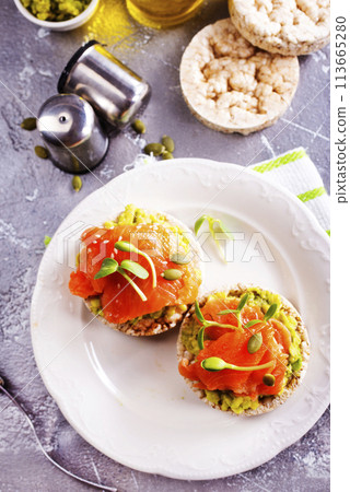 sandwiches with salmon and avocado on plate 113665280