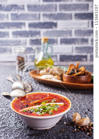 Traditional Ukrainian Russian borscht . Bowl of red beet root soup borsch with lard and dark bread Traditional Ukrainian Russian borscht . Bowl of red beet root soup borsch with lard and dark bread 113665287