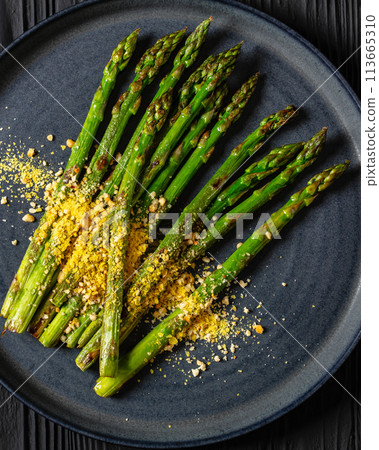 roasted asparagus with nut yeast crumble on plate roasted asparagus with nut yeast crumble on plate 113665310