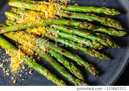 roasted asparagus with nut yeast crumble on plate roasted asparagus with nut yeast crumble on plate 113665312