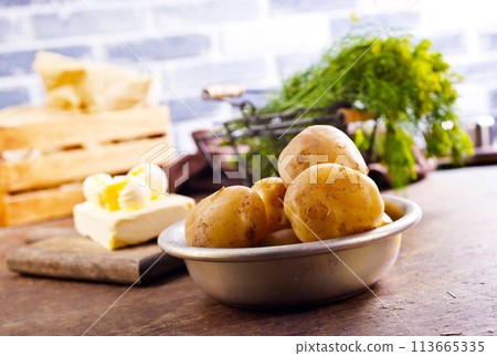 Fresh raw baby potato in bowl on wooden background. 113665335