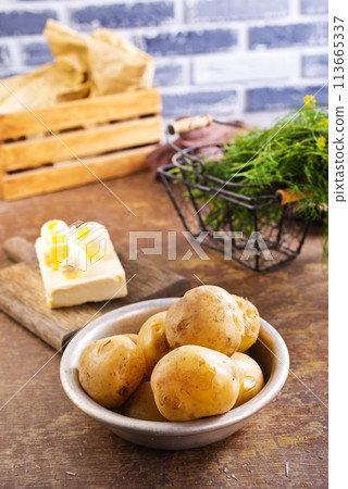 Fresh raw baby potato in bowl on wooden background. Fresh raw baby potato in bowl on wooden background. 113665337