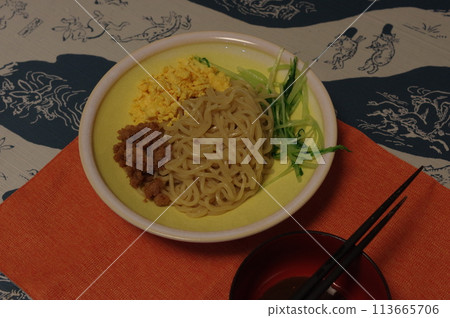 Tsukemen topped with scrambled eggs, minced chicken and mizuna Tsukemen topped with scrambled eggs, minced chicken and mizuna 113665706