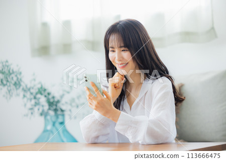 A woman watching a smartphone 113666475