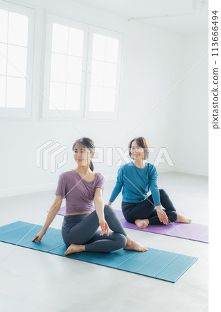 Woman practicing yoga in a yoga studio 113666494