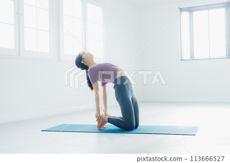 Woman practicing yoga in a yoga studio 113666527