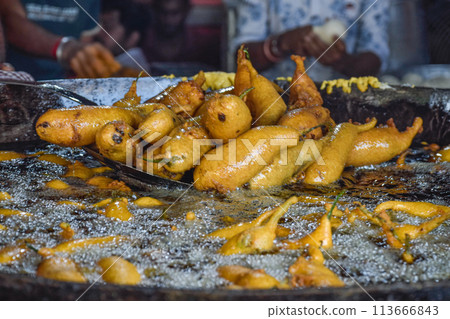 Traditional Mirch Pakoras Indian food as Samosas fried on street food and market 113666843
