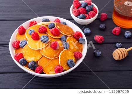 Mini pancakes with berries . Delicious breakfast 113667006