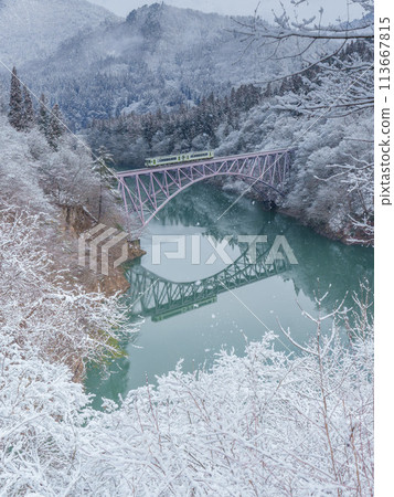 The Tadami Line crossing a snow-covered truss bridge The Tadami Line crossing a snow-covered truss bridge 113667815
