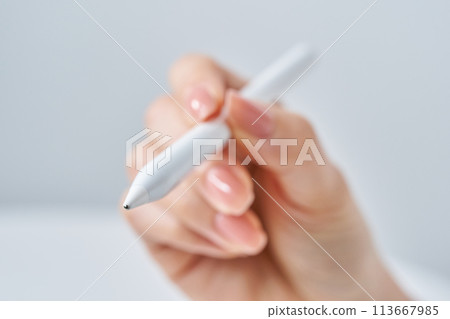 A woman's hand operating a stylus pen 113667985