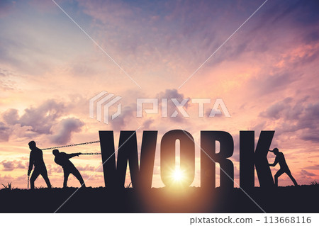 Silhouettes of people drawing the word WORK on a sunset background, business concept 113668116