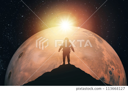 Silhouette of an astronaut on top of a mountain against the background of Mars. Elements of this image furnished by NASA 113668127