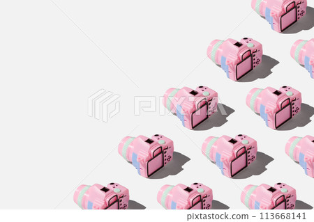 Pattern with SLR camera on pastel color background Pattern with SLR camera on pastel color background 113668141