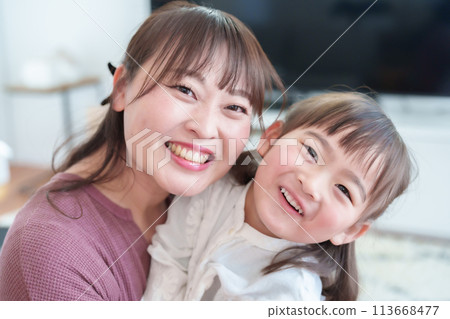 Parents and children taking selfies with a smartphone: Girl and mother 113668477