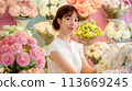 In Full Bloom, Woman Florist Inside a Flower Shop Working Among Colorful Flowers, Generative AI 113669245
