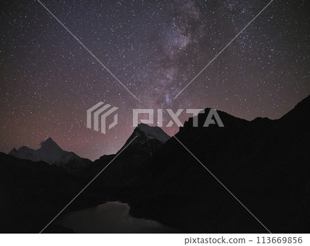 starry sky over mountain and lake in yading national park, china 113669856