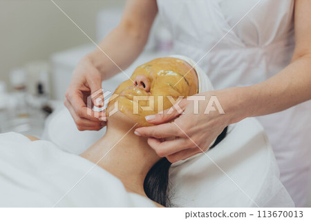 A girl at a cosmetologist does cosmetic procedures. Alginate mask A girl at a cosmetologist does cosmetic procedures. Alginate mask 113670013