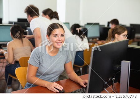 Teacher works at computer in the classroom. Students doing programming 113670778
