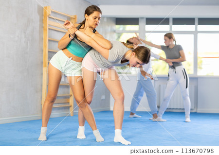 Females practicing self defence moves Females practicing self defence moves 113670798