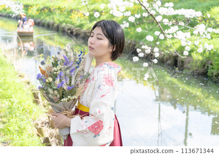 A female college student in a hakama holding a bouquet A female college student in a hakama holding a bouquet 113671344