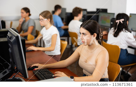 Teenage girl using computer during lesson Teenage girl using computer during lesson 113671361
