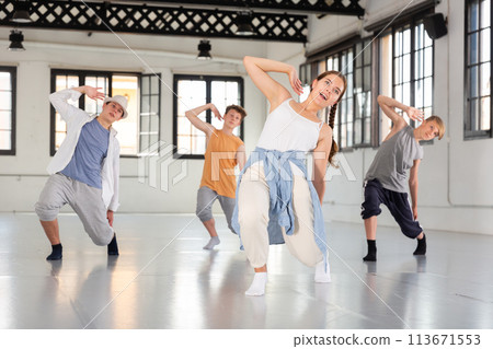Group teenagers dancing hip-hop indoors Group teenagers dancing hip-hop indoors 113671553