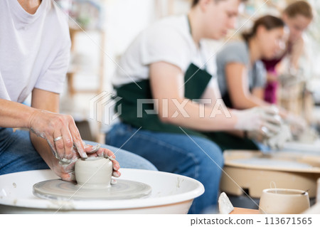 Making clay product on potter's wheel close-up 113671565