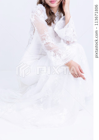 A woman wearing a white tight dress A woman wearing a white tight dress 113671806