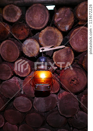 Camping at Lake Kawaguchi, Mt. Fuji in Japan. Beautiful warm light oil lamps, gasoline lanterns and logs. 113672226