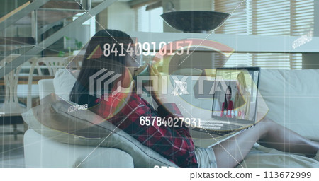 Image of numbers changing over woman using laptop on image call in background Image of numbers changing over woman using laptop on image call in background 113672999