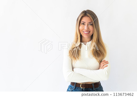 Portrait of a young Caucasian woman with pleasant smile and crossed arms isolated on white wall Portrait of a young Caucasian woman with pleasant smile and crossed arms isolated on white wall 113673462