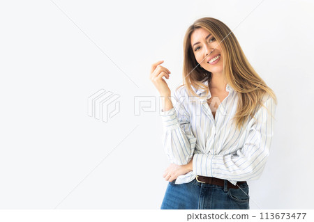 Portrait of a young relaxed Caucasian woman with pleasant smile isolated on white wall background Portrait of a young relaxed Caucasian woman with pleasant smile isolated on white wall background 113673477