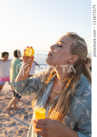 Young Caucasian woman enjoys a beach party Young Caucasian woman enjoys a beach party 113673575