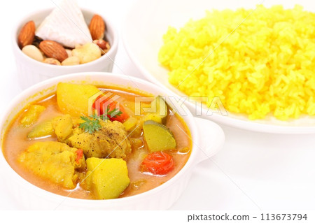 Nepalese soup curry with zucchini, chicken, potatoes and yellow rice on a light background Nepalese soup curry with zucchini, chicken, potatoes and yellow rice on a light background 113673794