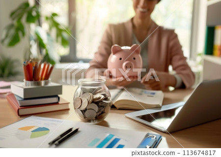 A woman is sitting at a desk with a piggy bank... - Stock Illustration ...