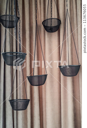 Empty hanging pot for orchids against white bricks wall Empty hanging pot for orchids against white bricks wall 113676055