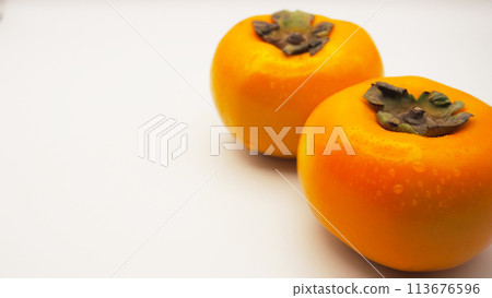 Isolated (cut out) of persimmon (kaki) fruit on white background Isolated (cut out) of persimmon (kaki) fruit on white background 113676596