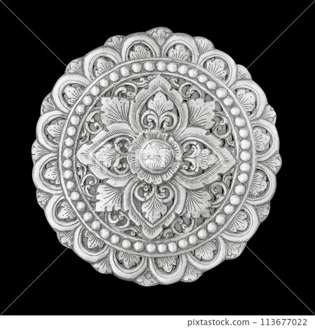 Silver decorative element with floral carved pattern isolated on black background. 113677022